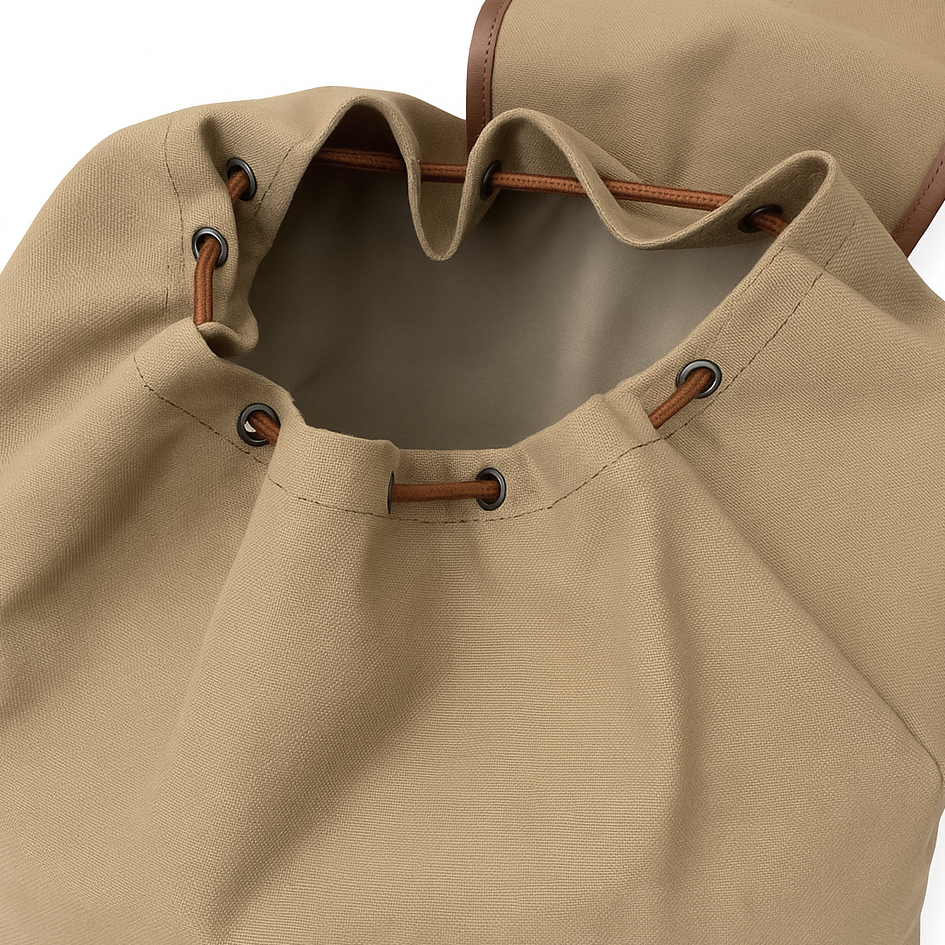 Close-up of a beige backpack with leather straps and buttons on a white background