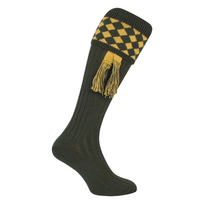 Green knee-high sock with yellow checkered pattern and tassels on a white background