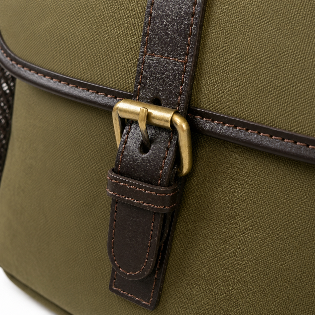 Close-up of a green dog training bag with a brown leather strap and gold buckle.