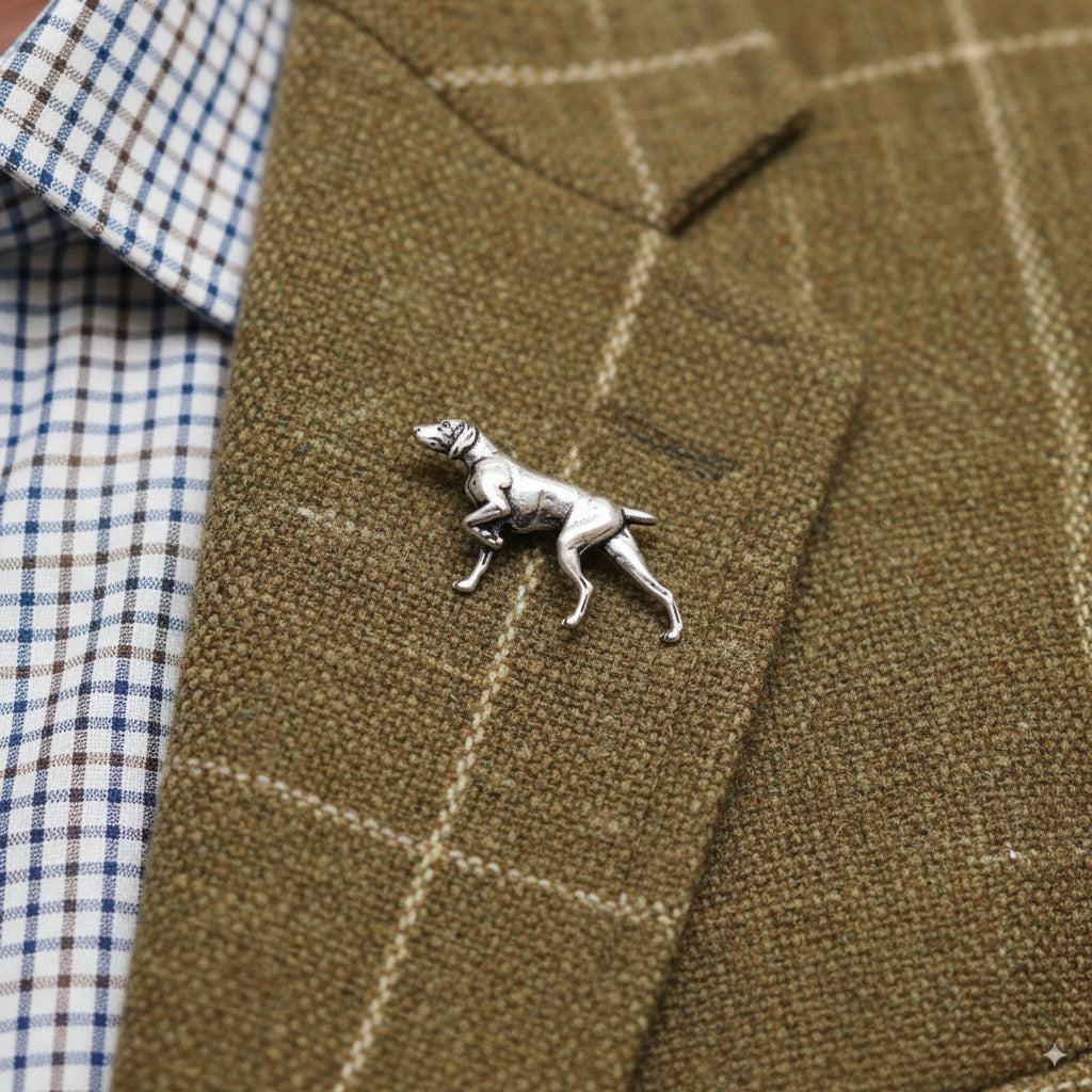 Silver pointer pin on a brown checkered suit jacket
