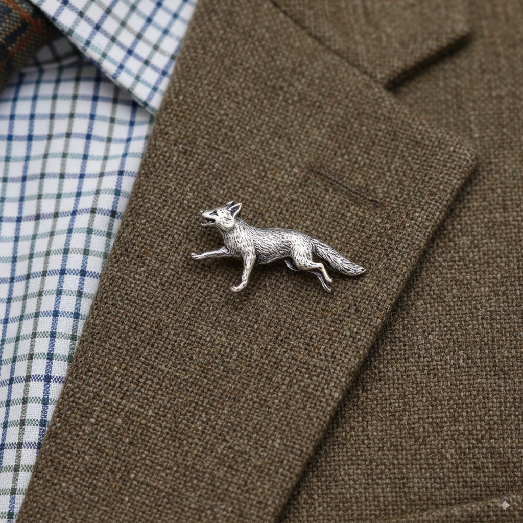Silver fox lapel pin on a brown jacket with plaid shirt