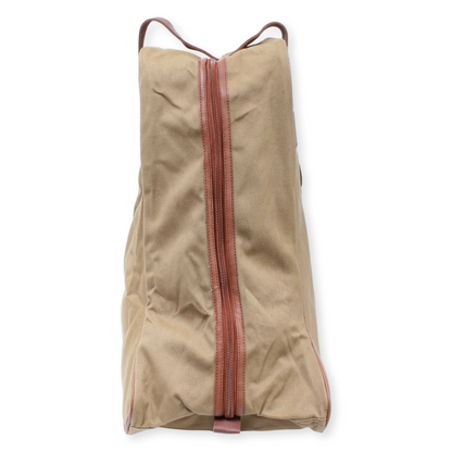 Beige travel bag with a red zipper on a white background