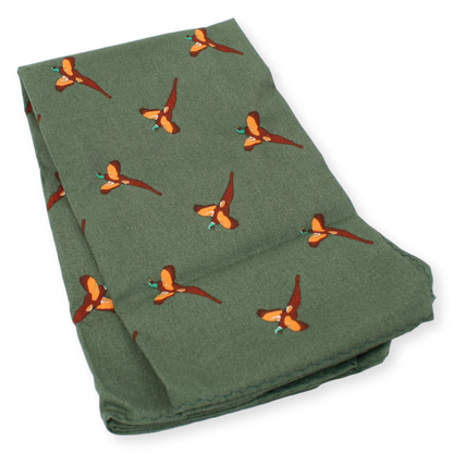 Folded green blanket with orange pheasant pattern on a white background