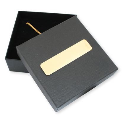 Black jewelry box with a gold nameplate on a white background