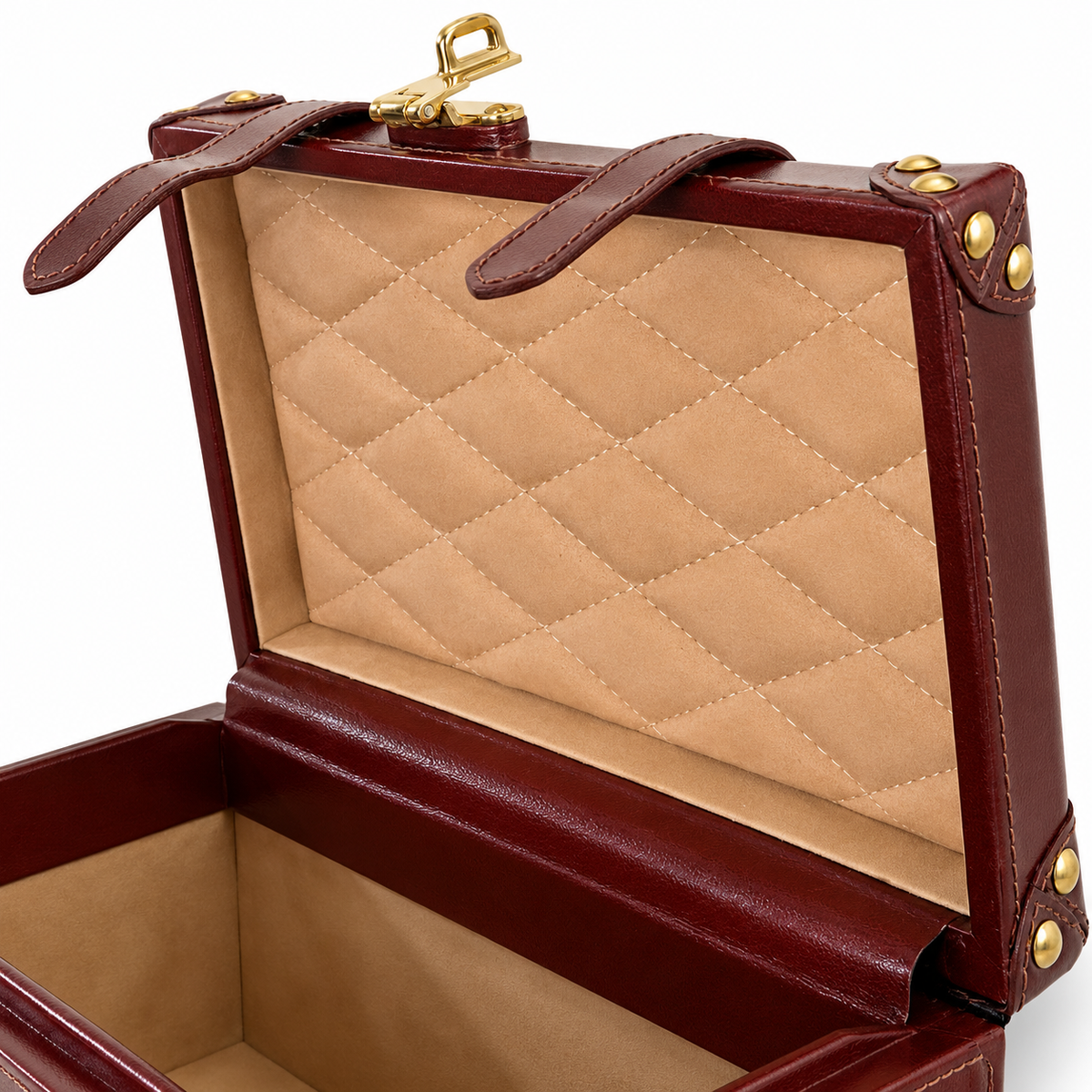 An open leather storage case or jewelry box with a quilted tan interior and dark reddish-brown exterior, accented with gold-tone hardware.