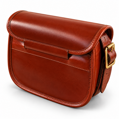 A brown leather cartridge bag with a gold-tone buckle, shown from a three-quarters angle on a white background.
