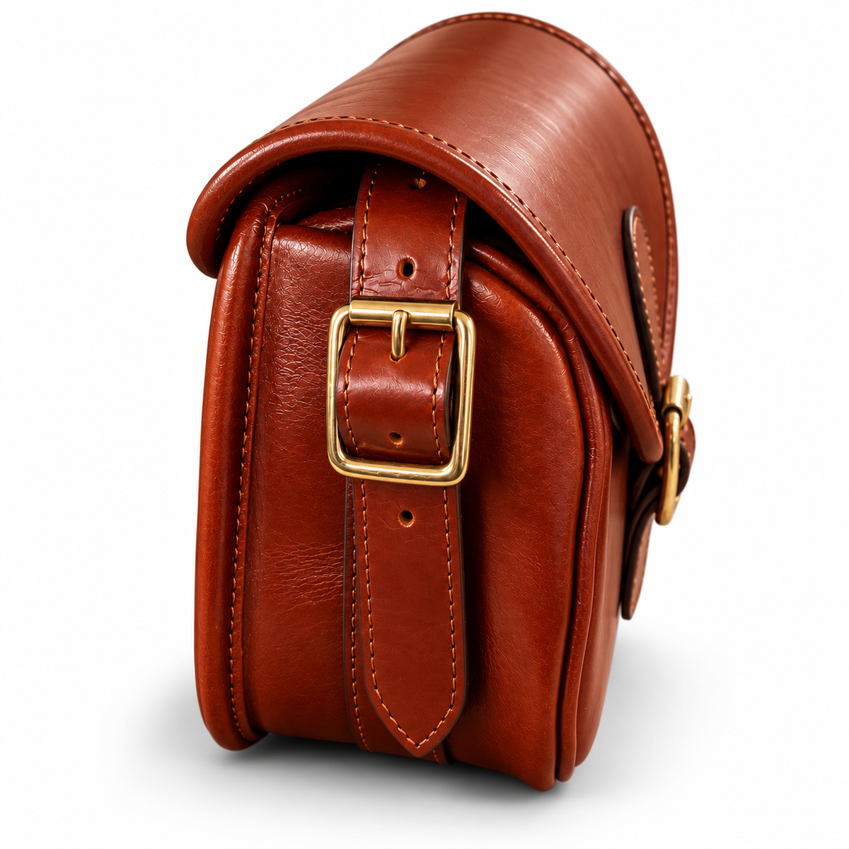 A brown leather cartridge bag with a gold-tone buckle closure, shown on a clean white background.