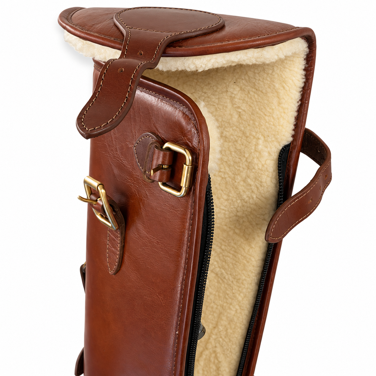 Close-up of a brown leather gun case with a cream sherpa lining and brass buckle details, shown on a white background.