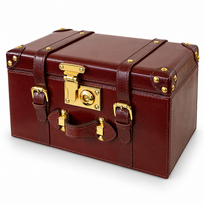 A vintage-style leather trunk or storage box in deep burgundy brown with polished gold-tone metal hardware, corner protectors, and a top handle, shown on a clean white background.