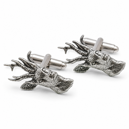 A pair of pewter metal cufflinks shaped like stag heads with detailed antlers, shown on a clean white background.