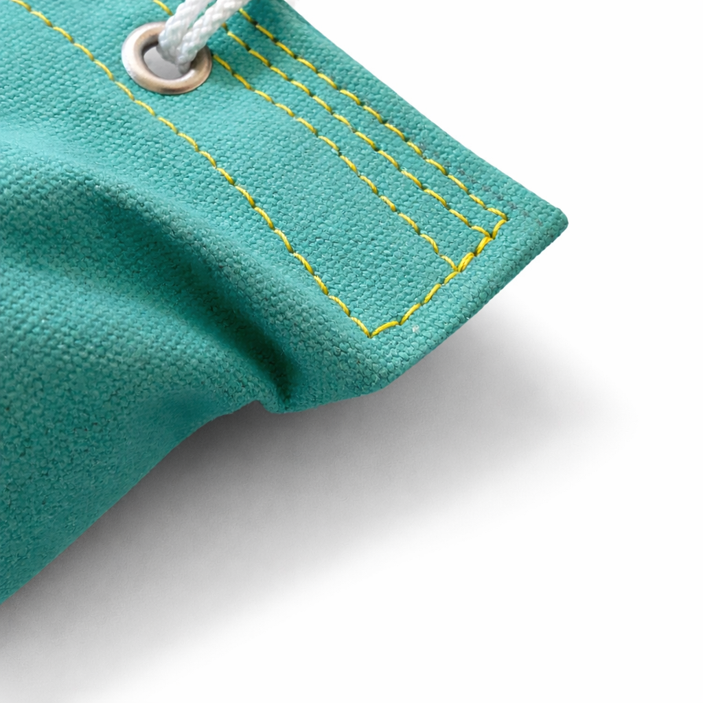 close up of teal fabric dog dummy on a white background