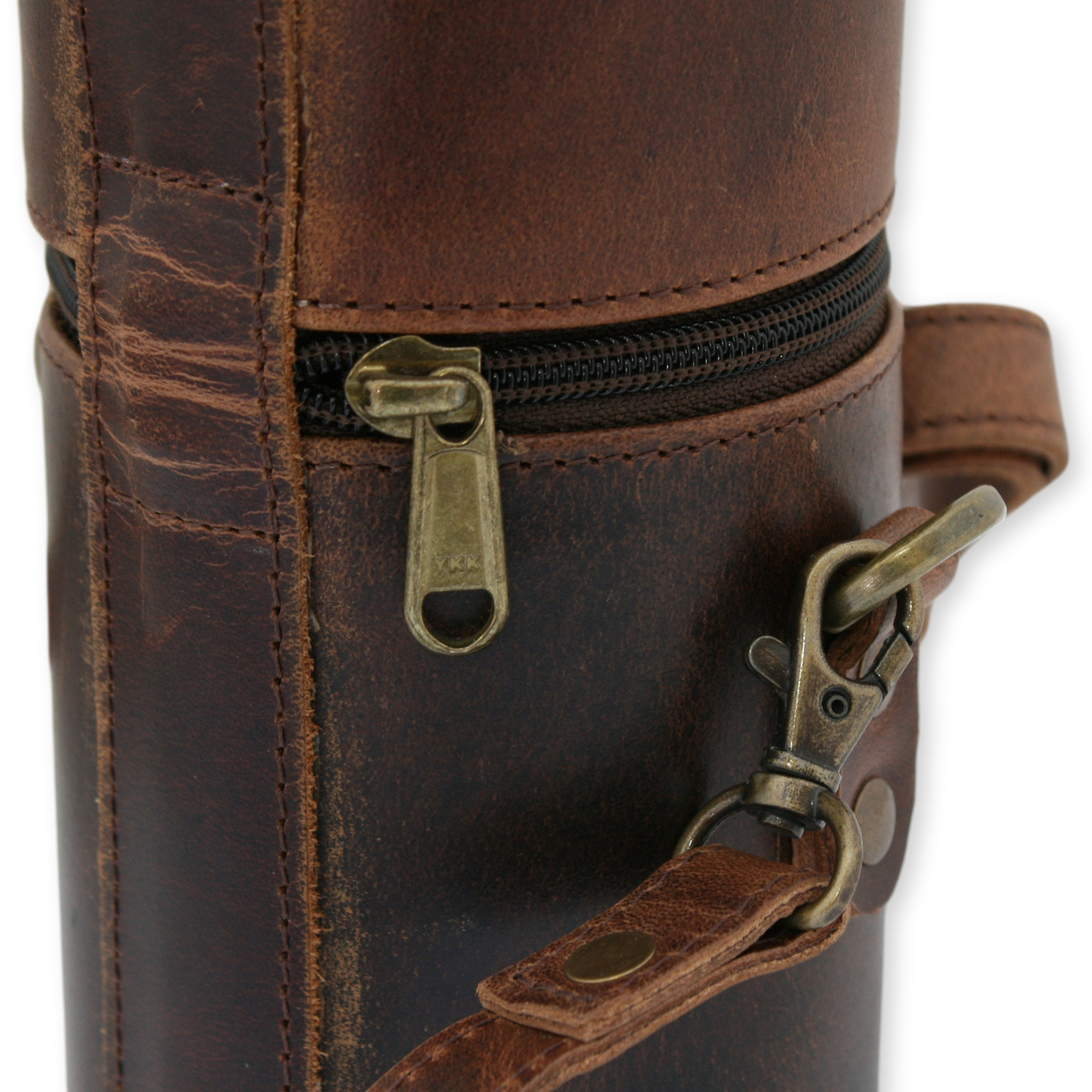 Pheasant Shooting Close-up of a brown leather bag with a zipper and strap on a white background