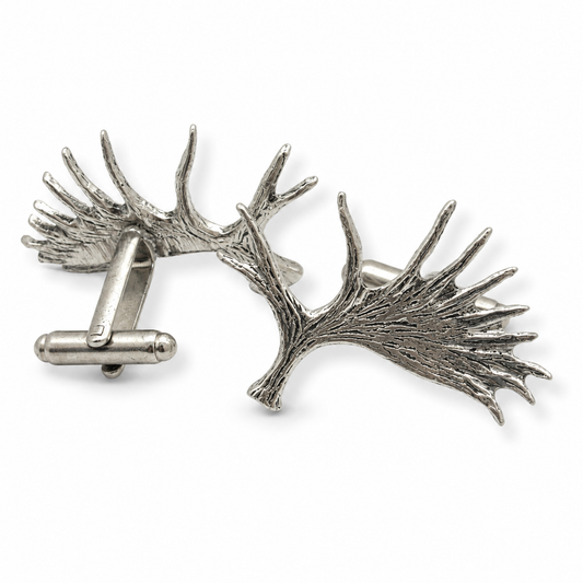 A pair of pewter cufflinks shaped like moose antlers with detailed textures, shown on a clean white background.