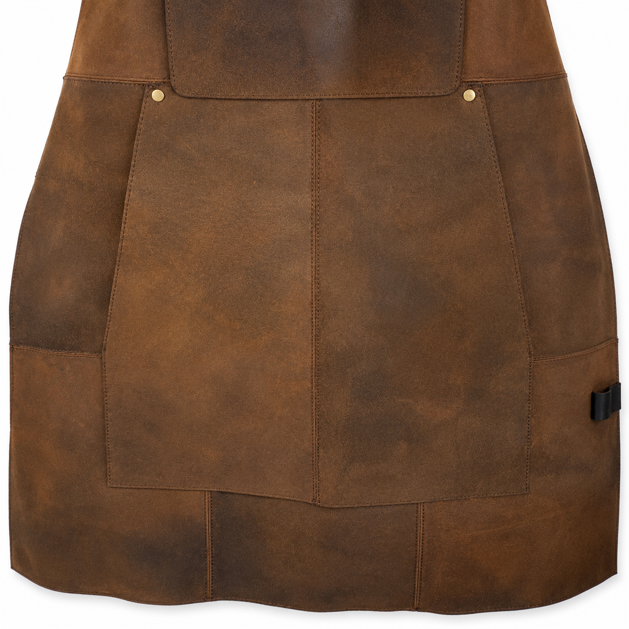 Close-up of a brown leather gunsmith's apron with stitched panelling, brass-tone rivets, and a small black plastic hook-and-loop fastener on the right side, shown against a white background.