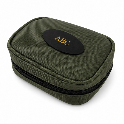 An olive green zippered fabric rifle cleaning case with a black oval patch on top featuring the gold embroidered letters 'ABC'.