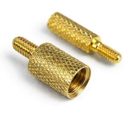 Two gold-colored metallic connectors on a white background
