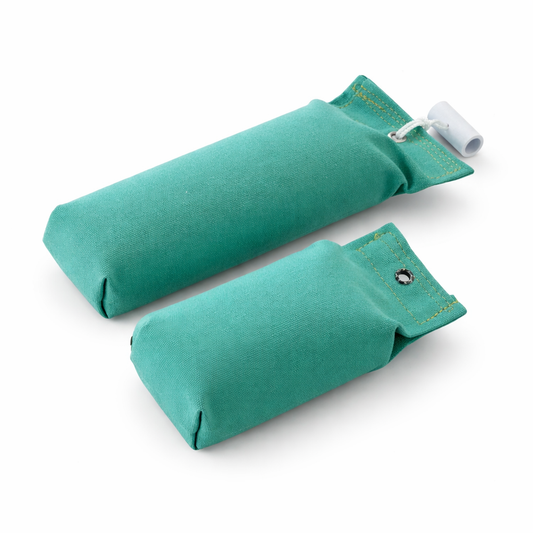 Two teal fabric dog training dummies on a white background