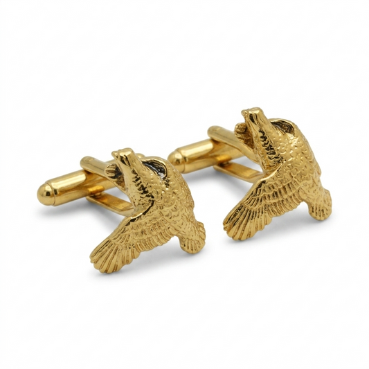 A pair of gold-toned cufflinks shaped like flying birds, shown on a clean white background.