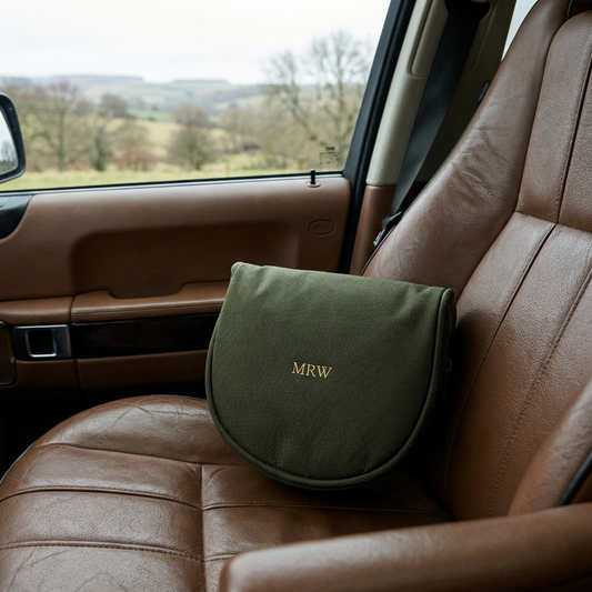 green embossed ear defender case on a leather car seat