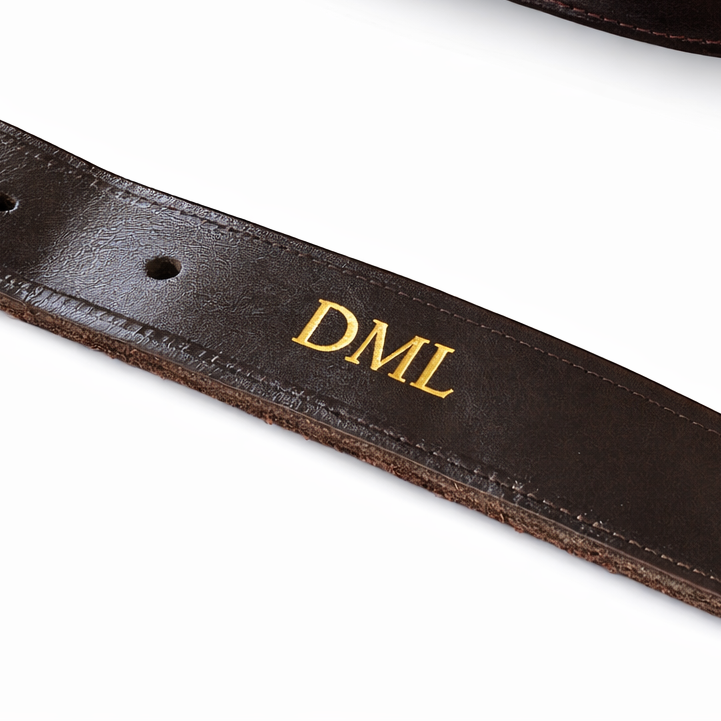Brown leather gun case with 'DML' embossed leather on a white background