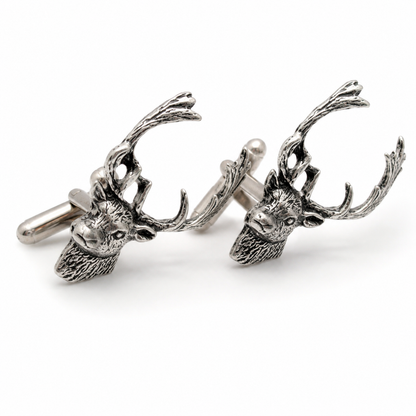 A pair of pewter cufflinks shaped like fallow deer heads with detailed antlers, shown on a clean white background.
