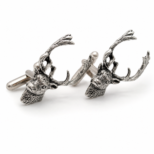 A pair of pewter cufflinks shaped like fallow deer heads with detailed antlers, shown on a clean white background.