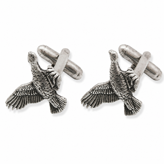 A pair of pewter cufflinks shaped like flying grouse with detailed feather textures, shown on a clean white background.