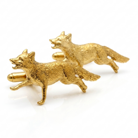 A pair of gold plated cufflinks shaped like running foxes, photographed on a clean white background.