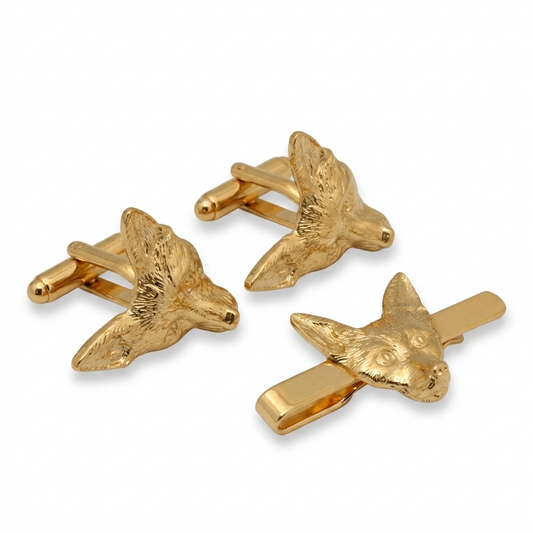 gold-toned cufflinks & tie slide shaped like fox heads, displayed on a clean white background.