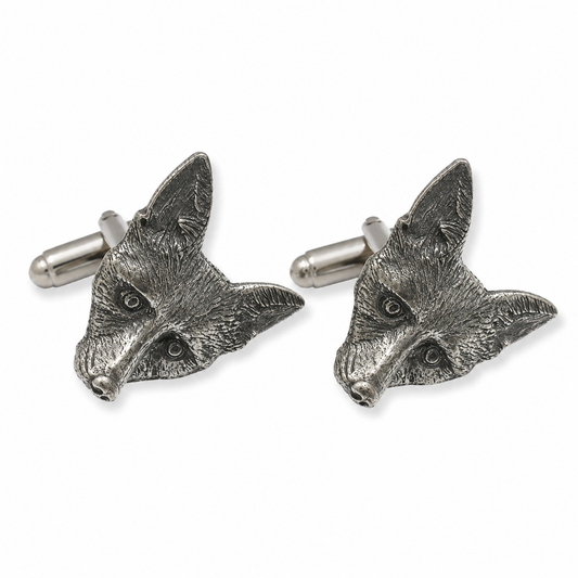 A pair of pewter cufflinks shaped like fox heads, shown on a clean white background.