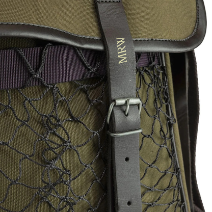 Close-up of a green game bag with a netting and brown strap.
