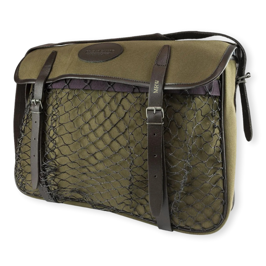 Green game bag with netting and brown straps on a white background