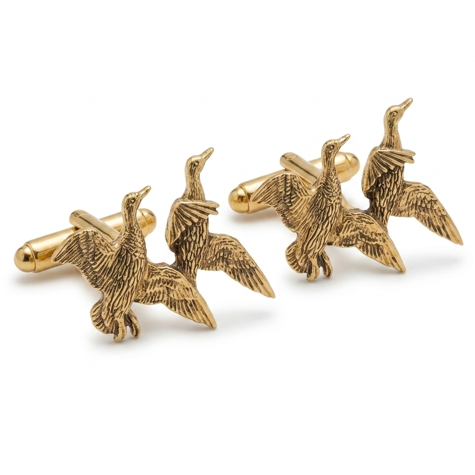A pair of gold-toned cufflinks shaped like flying ducks, displayed on a clean white background.