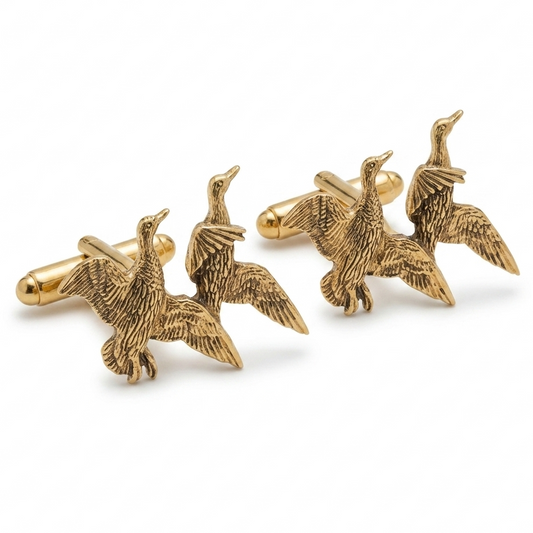 A pair of gold-toned cufflinks shaped like flying ducks, displayed on a clean white background.