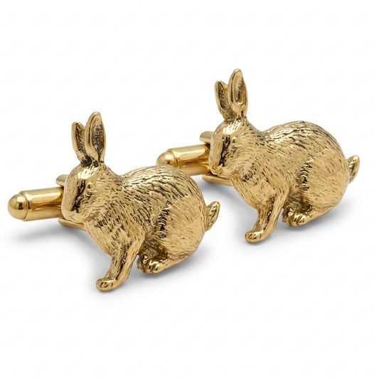 A pair of gold plated cufflinks shaped like rabbits, shown on a clean white background.