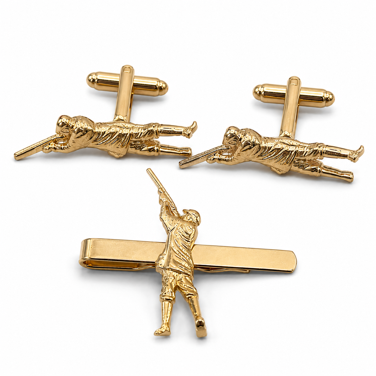 Three-piece gold-tone cufflinks and tie clip set featuring a sculpted figure of a game shooter, shown on a clean white background.
