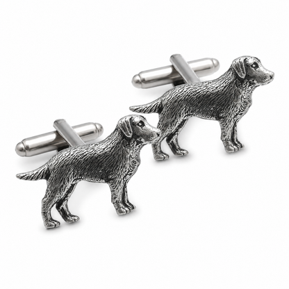 A pair of pewter cufflinks shaped like standing labrador dogs, photographed on a clean white background.
