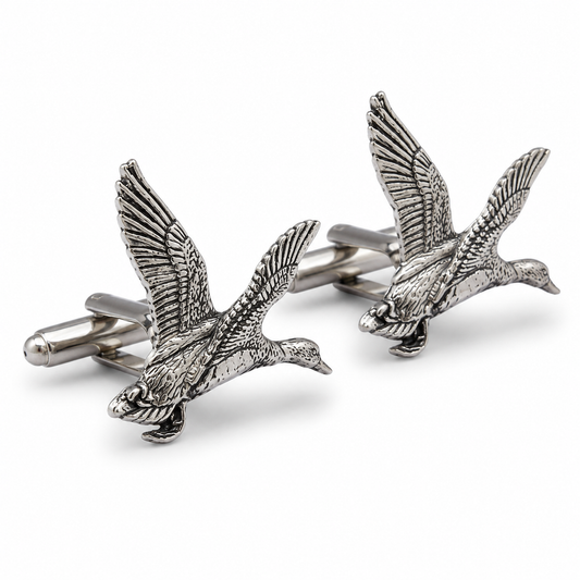 A pair of pewter cufflinks shaped like flying ducks in flight, shown on a clean white background.