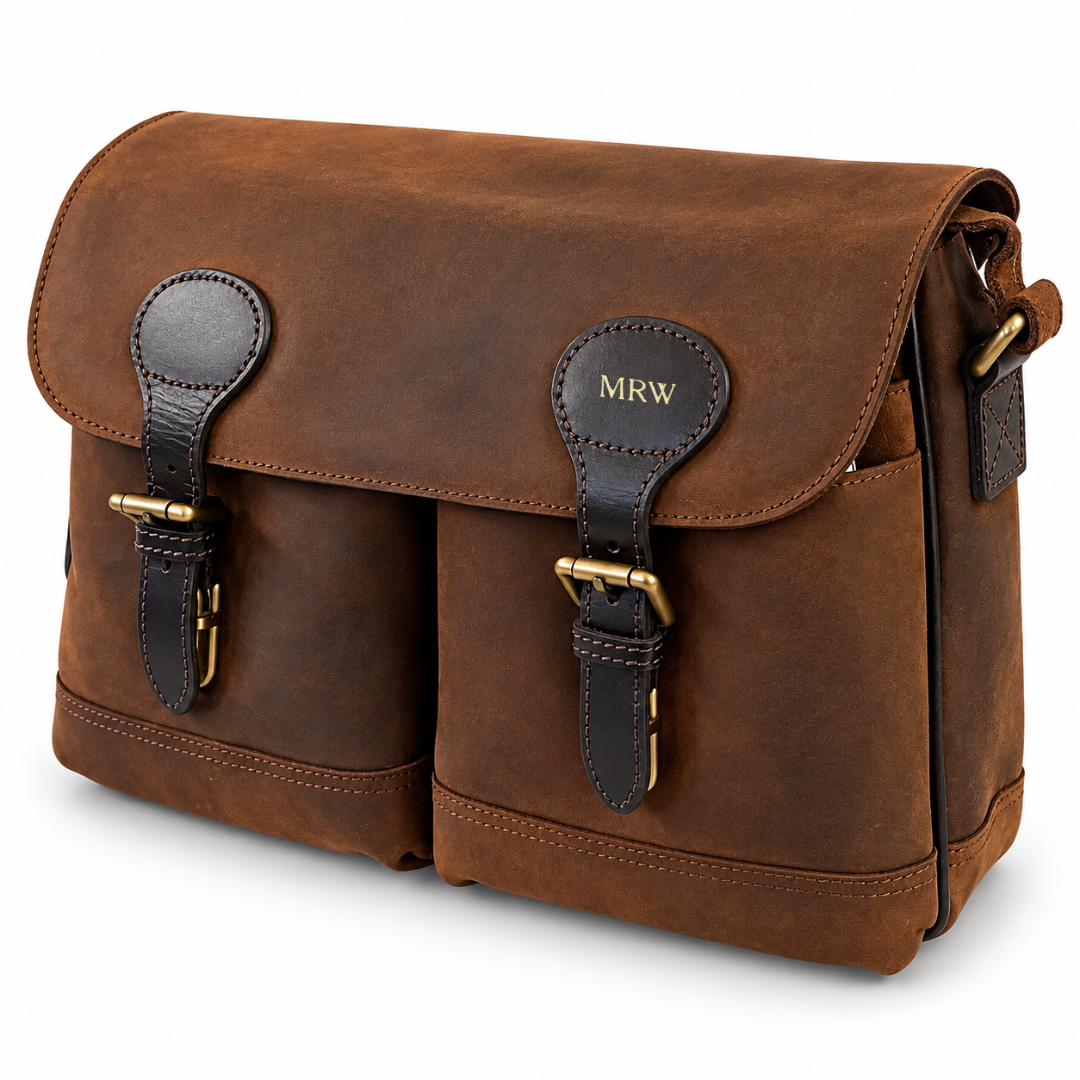 A brown leather messenger bag with two front buckle straps, a top flap, and a shoulder strap, shown on a clean white background.