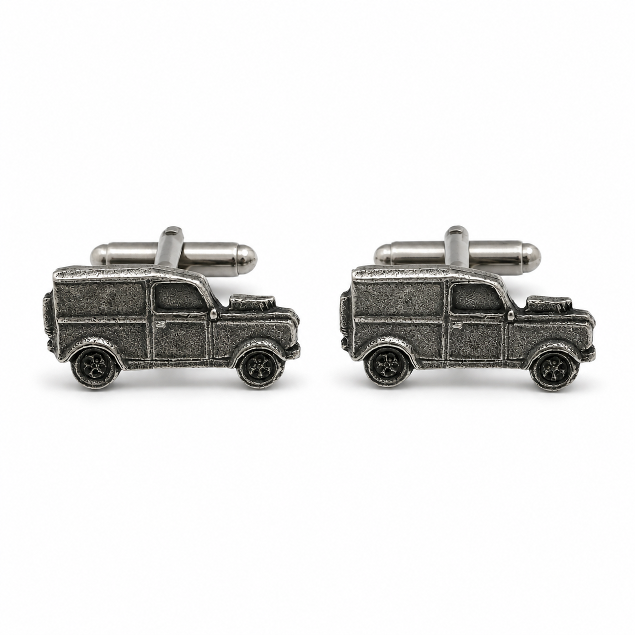 A pair of pewter cufflinks shaped like vintage 4x4s, shown on a clean white background.