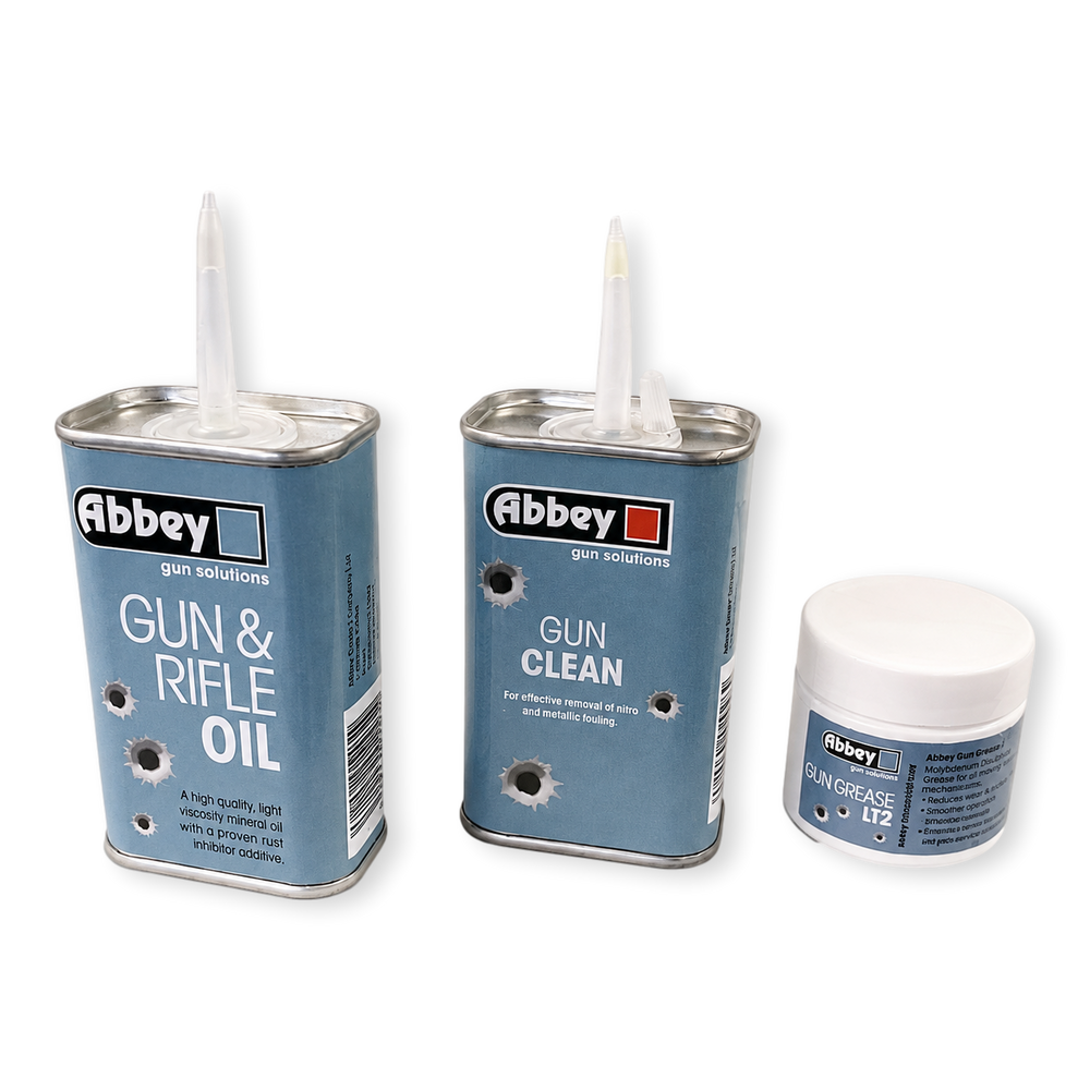 Three canisters of Abbey gun solutions products on a white background: Gun & Rifle Oil, Gun Clean, and Skin Grease No. 12.