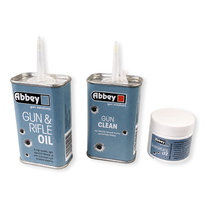 Three canisters of Abbey gun solutions products on a white background: Gun & Rifle Oil, Gun Clean, and Skin Grease No. 12.