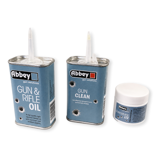Three canisters of Abbey gun solutions products on a white background: Gun & Rifle Oil, Gun Clean, and Skin Grease No. 12.
