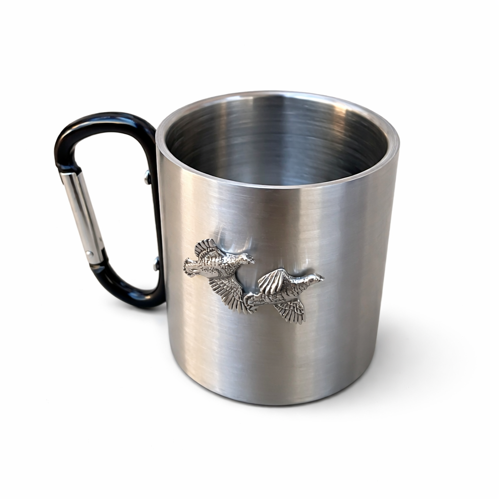 Stainless steel mug with black carabiner handle and partridge emblem on a white background