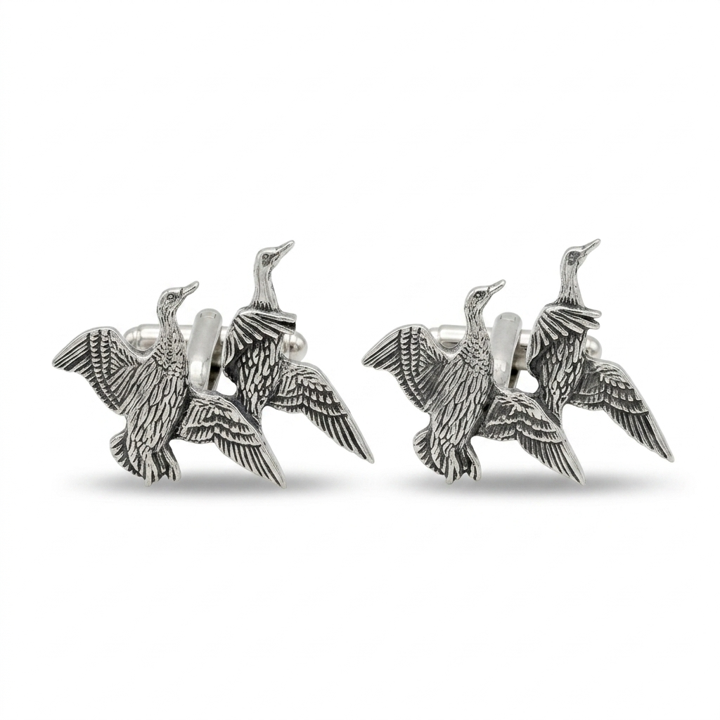 A pair of silver-toned cufflinks shaped like flying ducks, shown on a clean white background.
