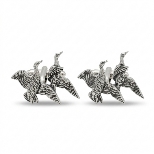 A pair of silver-toned cufflinks shaped like flying ducks, shown on a clean white background.