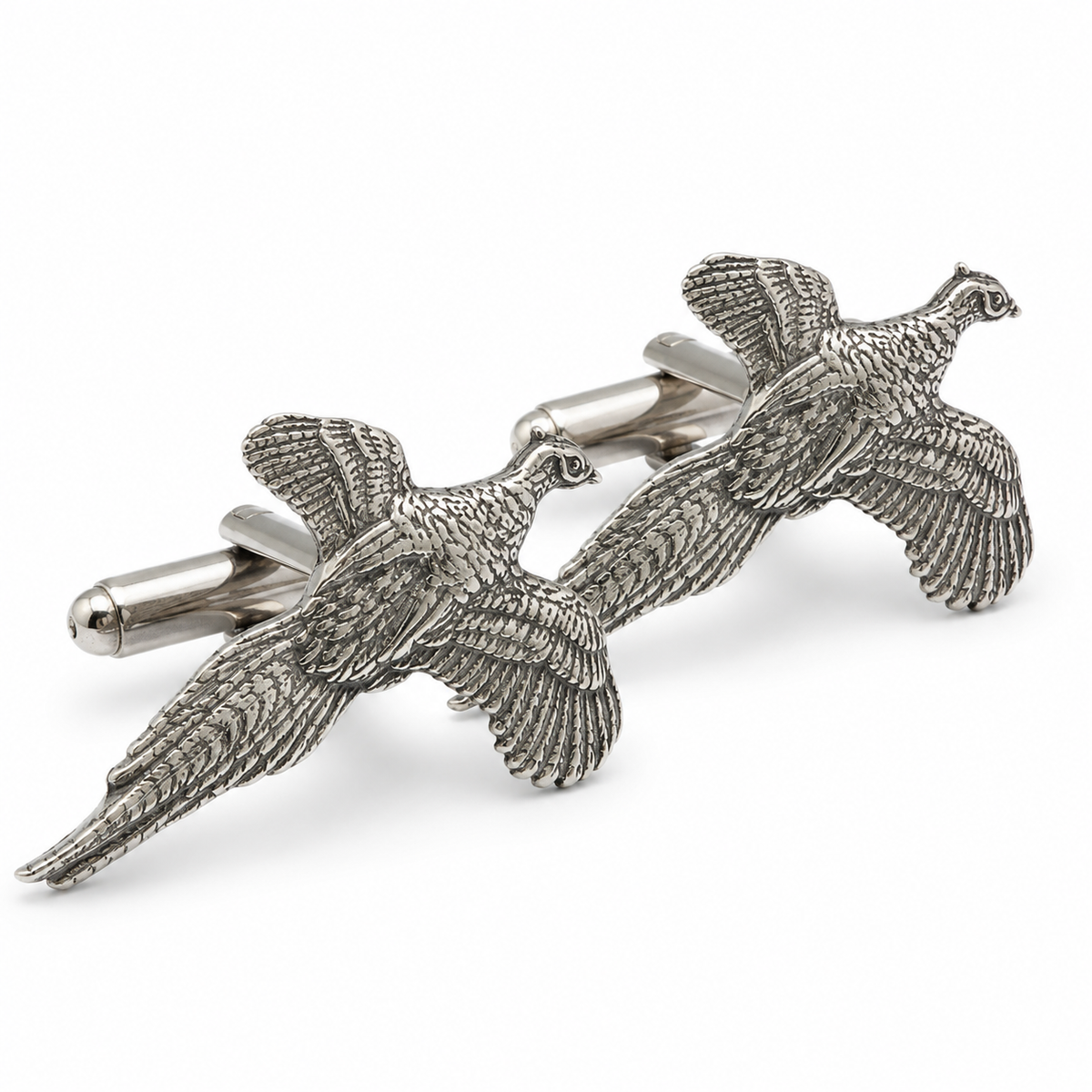 A pair of pewter cufflinks shaped like flying pheasants, shown on a clean white background.