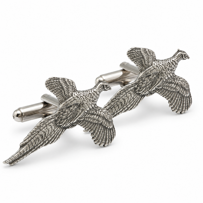 A pair of pewter cufflinks shaped like flying pheasants, shown on a clean white background.