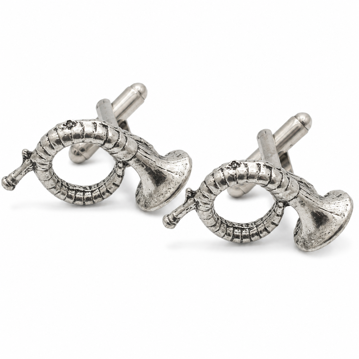 A pair of pewter cufflinks shaped like hunting horns, photographed on a clean white background.