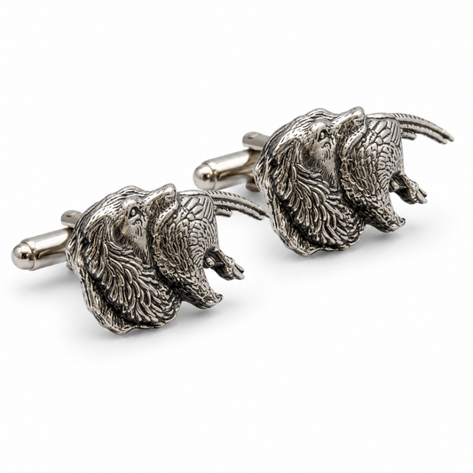 A pair of pewter cufflinks shaped like spaniel & Pheasants shown on a clean white background.